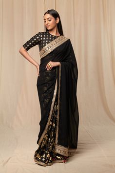 Editor's Note This black oasis saree comes with sheer palla is embellished with embroidered border and tassel detail to dazzle at a special occasion! It comes with black wallflower blouse piece Note: this sari is free size and comes with unstitched piece blouse (1 metre raw silk) Fabric: Raw Silk, organza Color: Black Fit: Free size Components: Sari and unstitched blouse piece Occasion: Festive and wedding guest Care: strictly dry clean only for digitally printed garments & non-petroleum dry cle