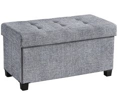 a gray ottoman with buttons on the top and legs, sitting in front of a white background