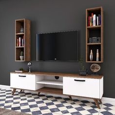 an entertainment center with bookshelves and a flat screen tv mounted on the wall