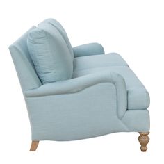 a light blue couch sitting on top of a white floor