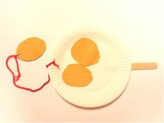 a paper plate with two pieces of food on it and a string attached to the side