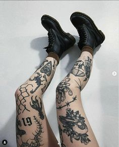 the legs and ankles of a woman with tattoos