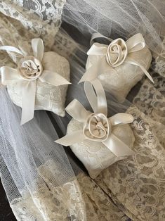 two wedding garters with bows and lace on them are sitting next to each other