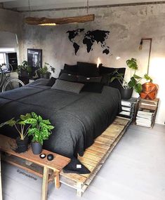 a bed room with a neatly made bed and lots of plants on the side table