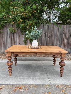 a wooden table sitting on top of a sidewalk