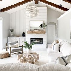 a living room filled with furniture and a fire place in the middle of the room