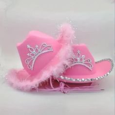 a pink cowboy hat with feathers on it