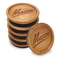 four wooden coasters with the word mason on them in brown and black lettering are stacked up next to each other