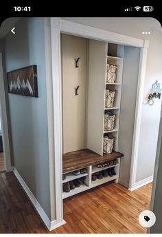 a room with some shelves and shoes on the floor next to a door that leads to another room