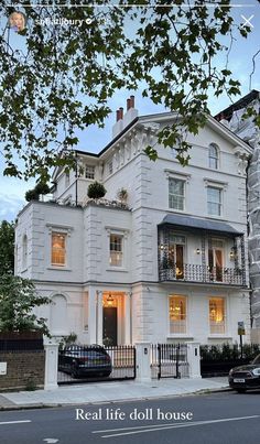 a large white house sitting on the side of a road