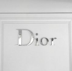 the word dior is cut out of metal