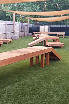 a wooden bench sitting on top of a lush green field