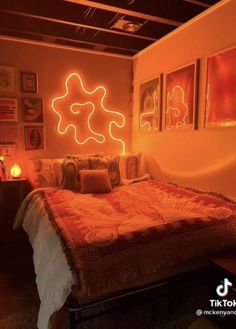 a bed sitting in a bedroom next to a wall with pictures on it and neon lights