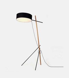 the floor lamp is made from wood and has a black shade on it's head