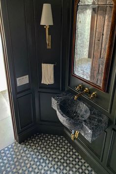 a bathroom with a sink and mirror next to a wall mounted cabinet in the corner