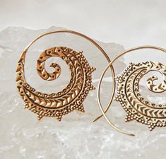 This earrings will compliment any outfit whether bohemian look or an elegant evening look. With it's Intricate and unique design you will complete any look. Unique Spiral Hoop Earrings, Single Wrap Earring For Festivals, Bohemian Gold Spiral Wrap Earrings, Bohemian Brass Wrap Earrings As Gift, Spiral Ear Wire Earrings For Festival, Gold Bohemian Wrap Earrings For Festivals, Bohemian Gold Wrap Earrings For Festival, Bohemian Gold Swirl Jewelry, Spiral Earrings For Festivals, Pierced Ears