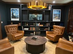 a living room filled with brown leather chairs