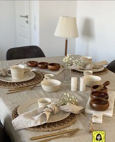 the table is set with plates and cups