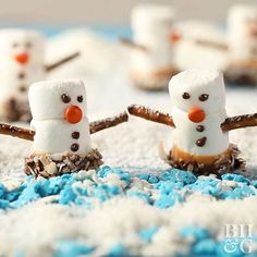 snowmen made out of marshmallows are sitting in the snow