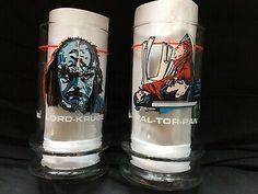 two glass cups with pictures of people on them