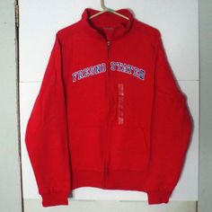 Fresno State Red Zip Up Sweatshirt In Size Large ( Tag Is Missing From Inside Of Sweatshirt But Sticker Is Still On The Outside). New Without Tags And In Excellent Condition Without Any Rips, Stains Or Tears. Has 2 Pockets In The Front And Has A Ribbed Pattern That Goes Under The Arms And Around The Bottom Of The Shirt (Sorry Hard To See In Pics). Width (Underarm To Underarm): 23 In Length (Top Of Shoulder To Bottom Jacket): 26 In Sleeve (Top Of Shoulder To Bottom Of Wrist Cuff): 25 In Red Cotton Outerwear With Letter Print, Casual Red College Sweatshirt, Red Casual College Sweatshirt, Collegiate Red Cotton Outerwear, Red Collegiate Cotton Outerwear, Red Cotton Collegiate Outerwear, Red Cotton College Style Tops, Red Winter Tops For College, Collegiate Red Tops For Winter