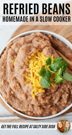 a bowl filled with refried beans and topped with cheese