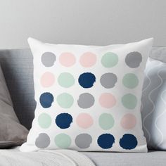 a polka dot pillow sitting on top of a couch