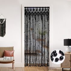 a living room with black and white decor on the wall, two chairs and a table