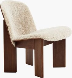 a wooden chair with a white sheepskin seat cover on it's backrest