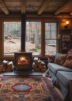 a living room filled with furniture and a fire place in the middle of a forest