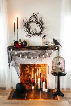 a fireplace decorated for halloween with candles and decorations