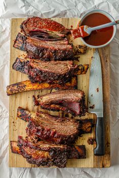 barbecue ribs on a cutting board with bbq sauce