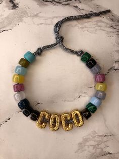 Personalised Multi Coloured Stone Big Bead Bracelet on Hand Tie Cord. One size fits all  Unisex Bracelet  You can add 3 gold letters of your choice they are personalised for you The lurex metal tipped cords come in a choice of 3 different colours. Gold, Silver or Dark Grey. If you would like to take a look at more of my designs and bespoke jewellery pop on to my Instagram feed Tosirwithlove_x Adjustable Gold Beaded Necklace With Letter Beads, Trendy Gold Jewelry With Gemstone Beads, Bohemian Silver Beaded Bracelets With Letter Beads, Party Jewelry With Gold Letter Beads, Bohemian Gold Necklaces With Letter Beads, Party Bracelet With Letter Beads, Party Jewelry Bracelet With Letter Beads, Party Letter Beads Bracelet Jewelry, Party Letter Beads Bracelet