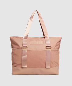 a pink tote bag with straps on it