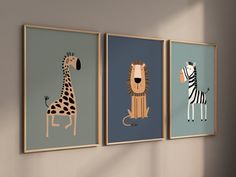 three framed pictures of animals hanging on the wall