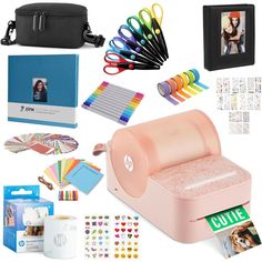 an assortment of office supplies including a printer, binder, and other items to make a photo album