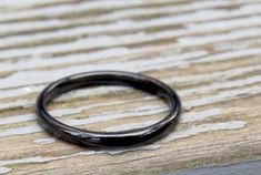 Offered is a minimalist black ring made out of TITANIUM and polished to a fabulous shine! Titanium is such a hard metal that it will never fade, scratch, bend, tarnish, or lose its polish. Additionally, it's hypoallergenic, making it a wonderful choice for a friendship, promise, engagement, and wedding ring! This is a SMALL, minimalist ring - the band width is 2mm. Please take a look at the third photo to get a sense of size. The ring comes in sizes 5, 6, 7, 8, and 9. Please use the drop down me Black Minimalist Stackable Rings, Minimalist Black Stackable Rings, Minimalist Black Stackable Rings With Round Band, Minimalist Black Hypoallergenic Rings, Promise Ring Simple, Friendship Ring, Simple Band, Friendship Rings, Titanium Ring