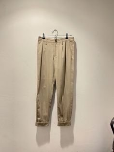 "Tan slacks with pleated details.  Waist: 15\" Rise: 10.5\" Length: 37\"" Fitted Beige Pleated Bottoms, Classic High Waist Spring Chinos, Classic High-waist Spring Chinos, Summer Formal Pleated Pants, Classic Stretch Pleated Bottoms, Classic Pleated Stretch Bottoms, High Waist Fitted Pleated Pants, High-waist Fitted Pleated Pants, Summer Pleated Tapered Leg Pants