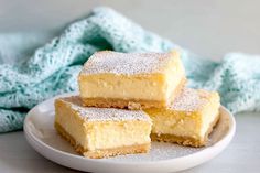 three pieces of cake sitting on top of a white plate next to a blue towel