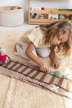 All aboard for imaginative play with the Ride and Roll Train Toy Set from Lorena Canals. This inventive design features an appealing plush train that comes with a long textile railroad track that measures more than 13 feet in length, providing plenty of space for grand adventures. Each set is beautifully handcrafted for timeless appeal. Made from quality fabrics and fibers that are leftover from other products at the Lorena Canals factory, the Ride and Roll collection gives premium materials a n Braided Basket, Kids Area Rugs, Slow Design, Lorena Canals, Rug Direct, All Aboard, Train Set, Red Dark, Toy Train