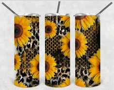 three sunflowers on a black and white background with two straws in each one