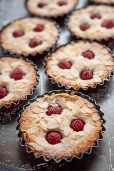 some raspberry pies are sitting on top of a metal tray and ready to be eaten