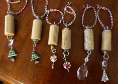 several wine corks with christmas decorations hanging from them