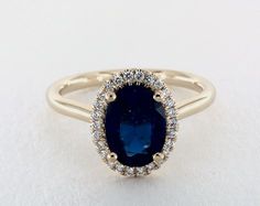 an oval shaped blue sapphire and diamond halo ring