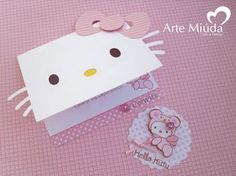 a hello kitty gift box with its lid open and some stickers on the side