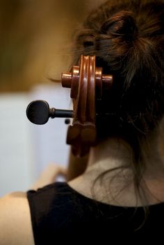 a woman with a microphone in her hair looking at the back of her head,