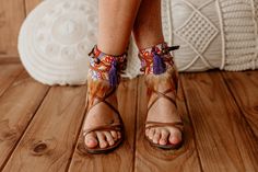 Elevate your summer footwear with our Stunning Purple and Orange Feather Fringe Sandal Ankle Ties. These flat shoe accessories feature decorative laces and leather sandal ankle wraps adorned with vibrant feather fringe. Perfect for adding a bohemian flair to your ensemble, they blend artisan craftsmanship with bold summer hues, making every step a statement of unique style and free-spirited elegance. * This ad is for a pair of anklets; footwear is not included. * If you need a custom design or f Brown Bohemian Sandals With Ankle Strap, Bohemian Brown Sandals With Ankle Strap, Bohemian Brown Ankle Strap Sandals, Summer Vacation Lace-up Sandals With Heel Strap, Bohemian Ankle Strap Summer Heels, Bohemian Ankle Strap Heels For Summer, Bohemian Ankle Strap Heels For Spring, Leather Barefoot Sandals With Ankle Wrap For Summer, Leather Ankle Wrap Barefoot Sandals For Summer