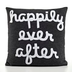 a pillow with the words happily ever after printed in white letters on it's back