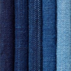 several different colors of fabric are shown in this close up photo, including blue and white