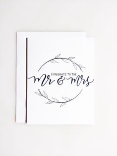 congratulations to the mr and mrs card on top of a white envelope with blue ink